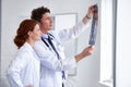 Learning something new everyday. Shot of two doctors assessing a patients x-ray at the hospital.