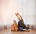 He knows just how to entertain his little brother. Shot of two little boys playing together at home. Royalty Free Stock Photo