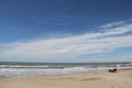 Shot of two people sitting on the chairs in the beach looking at the ocean waves and relaxing Royalty Free Stock Photo