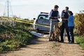 An unfortunate end. Shot of two policemen interviewing a woman at a crimescene.