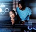 Reading the data over again. Shot of two programmers working together on a computer code at night. Royalty Free Stock Photo