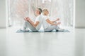 Shot of two senior people doing yoga in the class. Fitness people sitting on the exercise mat and relaxing in yoga position. Group Royalty Free Stock Photo