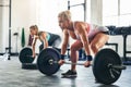 Levelling up on their fitness game. Shot of two sporty young woman lifting weights at the gym. Royalty Free Stock Photo