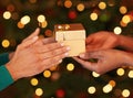 Tis better to give than to receive. Shot of two unrecognizable women exchanging gifts at Christmas. Royalty Free Stock Photo