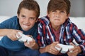 Ive got you this time. Shot of two young boys playing video games at home. Royalty Free Stock Photo