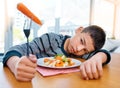I think Ive lost my appetite now. Shot of an unhappy young boy refusing to eat his vegetables at home. Royalty Free Stock Photo