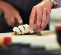 Looks good enough to eat. Shot of an unidentifiable young man preparing sushi in his kitchen. Royalty Free Stock Photo