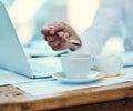 Adding some sweetener to his drink. Shot of an unrecognisable businessman pouring a teaspoon of sugar into a cup of tea Royalty Free Stock Photo