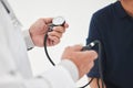 Your health should be a priority. Shot of an unrecognizable doctor monitoring a patients blood pressure at a hospital.