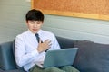 Shot of unrecognizable unknown male businessman employee in formal business outfit sitting on cozy sofa couch with laptop holding Royalty Free Stock Photo