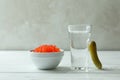 Shot of vodka, caviar and pickle on white wooden background Royalty Free Stock Photo