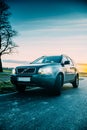 Shot of Volvo xc90 suv standing on field during sunset