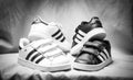 Shot of white adidas superstar sneakers and black adidas shoes. Image with selective focus