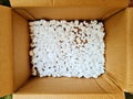 Shot of white polystyrene chips inside a brown box Royalty Free Stock Photo