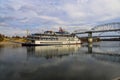 A shot of a white and red steam boat sailing on the Cumberland River near the John Seigenthaler Pedestrian Bridge Royalty Free Stock Photo