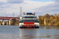 A shot of a white and red steam boat sailing on the Cumberland River near the John Seigenthaler Pedestrian Bridge Royalty Free Stock Photo