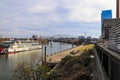 A shot of a white and red steam boat sailing on the Cumberland River near the John Seigenthaler Pedestrian Bridge Royalty Free Stock Photo