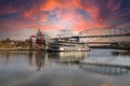 A shot of a white and red steam boat sailing on the Cumberland River near the John Seigenthaler Pedestrian Bridge Royalty Free Stock Photo