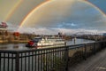 A shot of a white and red steam boat sailing on the Cumberland River near the John Seigenthaler Pedestrian Bridge Royalty Free Stock Photo