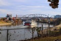 A shot of a white and red steam boat sailing on the Cumberland River near the John Seigenthaler Pedestrian Bridge Royalty Free Stock Photo