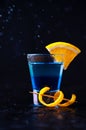 Shot with White Rum, Liquor Blue Curacao and Orange Slice. Alcoholic Layer Cocktail on Dark Background Royalty Free Stock Photo