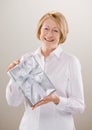 Shot of woman displaying classy wrapped gift