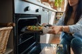 Young woman baking home pizza in kitchen at her home Royalty Free Stock Photo