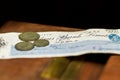 Some old british coins sit on top of a bank cheque from 1940 during world war 2 Royalty Free Stock Photo