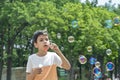 Shot of a young boy blowing bubbles in the park on vacation Royalty Free Stock Photo