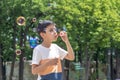 Shot of a young boy blowing bubbles in the park on vacation Royalty Free Stock Photo