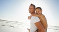 Father and son Ready for some summer fun. Shot of a young boy on his fathers back at the beach. Royalty Free Stock Photo