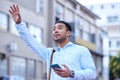 I need you to take me downtown. Shot of a young businessman hailing a cab. Royalty Free Stock Photo