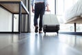 Young businessman with his luggage entering hotel suite Royalty Free Stock Photo