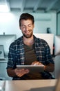 Time means nothing to him when there is a deadline. Shot of a young businessman working late at the office. Royalty Free Stock Photo