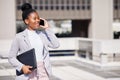 Id love to meet to discuss this. Shot of a young businesswoman making a phone call using her smartphone. Royalty Free Stock Photo