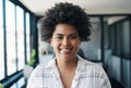 Minding my business because Im focusing on my business. Shot of a young businesswoman smiling in an office.