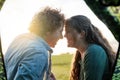 Budding romance in the great outdoors. Shot of a young couple bonding outside their tent on a camping trip. Royalty Free Stock Photo