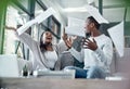 Fortune sides with the financially free. Shot of a young couple celebrating while going through paperwork at home. Royalty Free Stock Photo