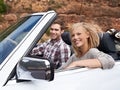 We love our weekend getaways. Shot of a young couple enjoying a drive in a convertible.