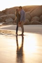 Lip locked. Shot of a young couple enjoying a romantic kiss on the beach at sunset. Royalty Free Stock Photo