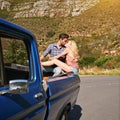 Travel brings power and love back into your life. Shot of a young couple sharing a kiss whole on the back of a pickup Royalty Free Stock Photo