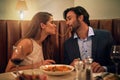 Nothing inspires romance quite like Italian food. Shot of a young couple sharing spaghetti during a romantic dinner at a Royalty Free Stock Photo