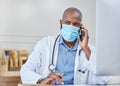 He can listen to your health needs. Shot of a young doctor on a call while writing in a notebook at work. Royalty Free Stock Photo