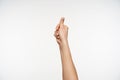 Shot of young fair-skinned female`s hand being raised while thumbing up, telling somebody that he is doing well on body languge, Royalty Free Stock Photo