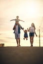 We love bonding over long walks. Shot of a young family taking a walk down the road outside. Royalty Free Stock Photo