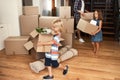 We all help out together as a family. Shot of a young family on their moving day. Royalty Free Stock Photo