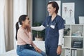 Everythings going to be okay. Shot of a young female doctor comforting a patient in an office.