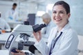 Youll never guess what Ive found. Shot of a young female lab tech using her microscope. Royalty Free Stock Photo