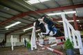 We ride, to fly, to feel. Shot of a young girl horse riding indoors. Royalty Free Stock Photo