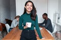 Young indian business woman entrepreneur looking at camera in the office